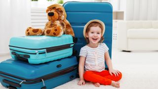Kind sitzt vor Urlaubskoffern, Foto: colourbox